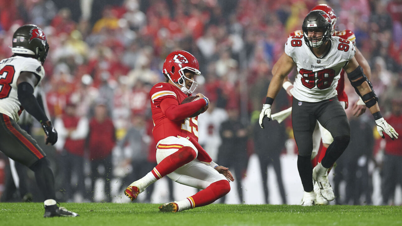 KANSAS CITY, MISSOURI - NOVEMBER 4: Patrick Mahomes #15 of the Kansas City Chiefs slides to the ground on a QB scramble during overtime against the Tampa Bay Buccaneers at GEHA Field at Arrowhead Stadium on November 4, 2024 in Kansas City, Missouri.