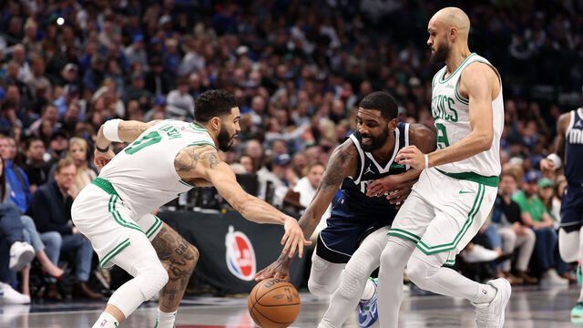 DALLAS, TEXAS - JANUARY 25: Kyrie Irving #11 of the Dallas Mavericks is defended by Jayson Tatum #0 and Derrick White #9 of the Boston Celtics during the fourth quarter at American Airlines Center on January 25, 2025 in Dallas, Texas. NOTE TO USER: User expressly acknowledges and agrees that, by downloading and/or using this photograph, user is consenting to the terms and conditions of the Getty Images License Agreement.