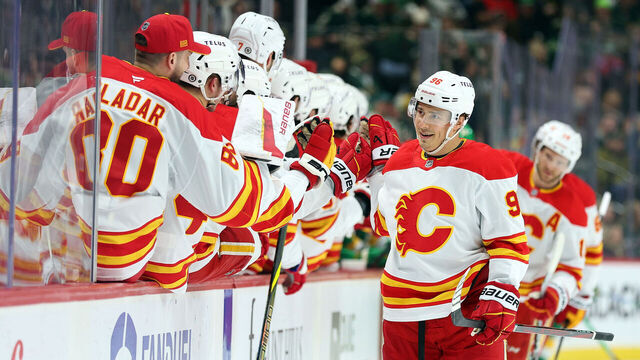 ST PAUL, MINNESOTA - JANUARY 25: Andrei Kuzmenko #96 of the Calgary Flames celebrates his power-play goal against the Minnesota Wild with teammates in the first period at Xcel Energy Center on January 25, 2025 in St Paul, Minnesota.