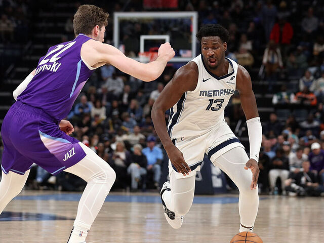 MEMPHIS, TENNESSEE - JANUARY 25: Jaren Jackson Jr. #13 of the Memphis Grizzlies handles the ball against Kyle Filipowski #22 of the Utah Jazz during the first half at FedExForum on January 25, 2025 in Memphis, Tennessee.