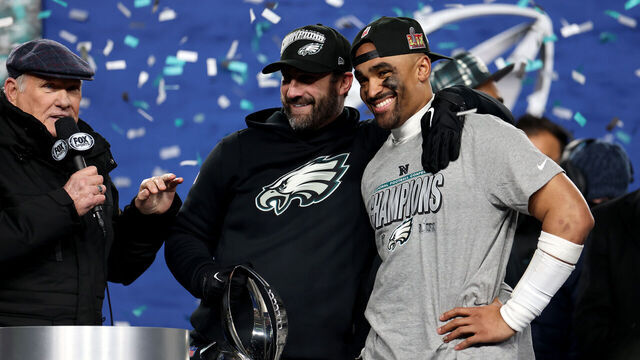 PHILADELPHIA, PENNSYLVANIA - JANUARY 26: Head coach Nick Sirianni and Jalen Hurts #1 of the Philadelphia Eagles smile during the trophy ceremony after defeating the Washington Commanders 55-23 to win the NFC Championship Game at Lincoln Financial Field on January 26, 2025 in Philadelphia, Pennsylvania.