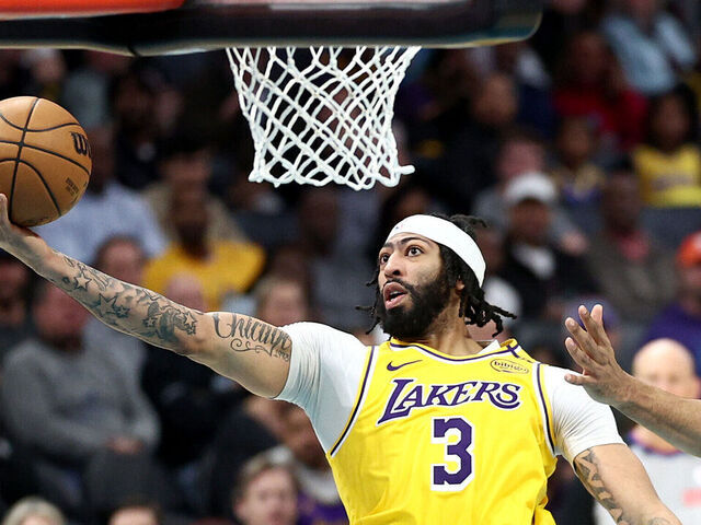CHARLOTTE, NORTH CAROLINA - JANUARY 27: Anthony Davis #3 of the Los Angeles Lakers attempts a lay up against Taj Gibson #67 of the Charlotte Hornets during the second half of the game at Spectrum Center on January 27, 2025 in Charlotte, North Carolina.