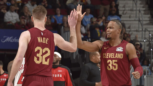CLEVELAND, OH - JANUARY 9: Dean Wade #32 and Isaac Okoro #35 of the Cleveland Cavaliers high five during the game against the Toronto Raptors on January 9, 2025 at Rocket Mortgage FieldHouse in Cleveland, Ohio. NOTE TO USER: User expressly acknowledges and agrees that, by downloading and/or using this Photograph, user is consenting to the terms and conditions of the Getty Images License Agreement. Mandatory Copyright Notice: Copyright 2025 NBAE