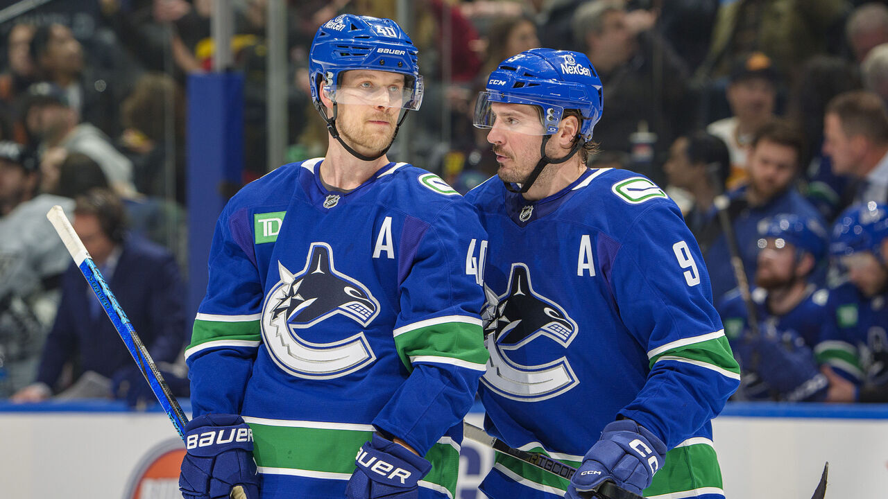 VANCOUVER, CANADA - JANUARY 16: J.T. Miller #9 and Elias Pettersson #40 of the Vancouver Canucks discuss game play during the second period of their NHL game against the Los Angeles Kings at Rogers Arena on January 16, 2025 in Vancouver, British Columbia, Canada.