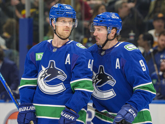 VANCOUVER, CANADA - JANUARY 16: J.T. Miller #9 and Elias Pettersson #40 of the Vancouver Canucks discuss game play during the second period of their NHL game against the Los Angeles Kings at Rogers Arena on January 16, 2025 in Vancouver, British Columbia, Canada.