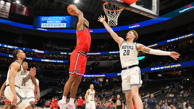 WASHINGTON, DC - JANUARY 28: Zuby Ejiofor #24 of the St. John's Red Storm dunks the ball over Drew Fielder #20 of the Georgetown Hoyas in the first half during a college basketball game at the Capital One Arena on January 28, 2025 in Washington, DC.