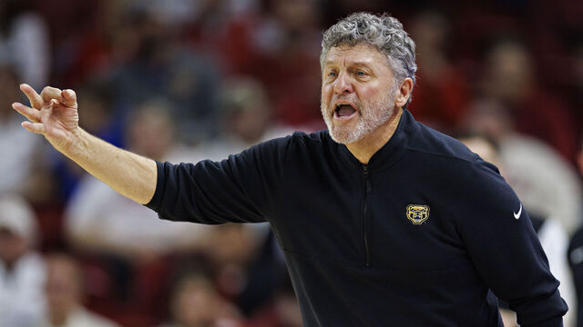 FAYETTEVILLE, ARKANSAS - DECEMBER 30: Head Coach Greg Kampe of the Oakland Golden Grizzlies directs his team during a game against the Arkansas Razorbacks at Bud Walton Arena on December 30, 2024 in Fayetteville, Arkansas. The Razorbacks defeated the Grizzlies 92-62.