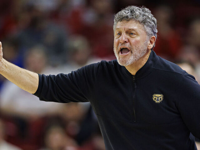 FAYETTEVILLE, ARKANSAS - DECEMBER 30: Head Coach Greg Kampe of the Oakland Golden Grizzlies directs his team during a game against the Arkansas Razorbacks at Bud Walton Arena on December 30, 2024 in Fayetteville, Arkansas. The Razorbacks defeated the Grizzlies 92-62.