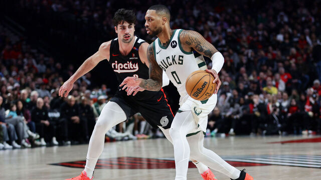 PORTLAND, OREGON - JANUARY 28: Damian Lillard #0 of the Milwaukee Bucks drives past Deni Avdija #8 of the Portland Trail Blazers during the third quarter at Moda Center on January 28, 2025 in Portland, Oregon.