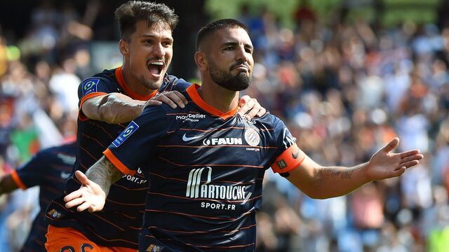 Montpellier's French forward Andy Delort (R) celebrates after scoring a goal during the French L1 football match between Montpellier Herault SC and FC Lorient at the Mosson stadium in Montpellier, southern France on August 22, 2021.
