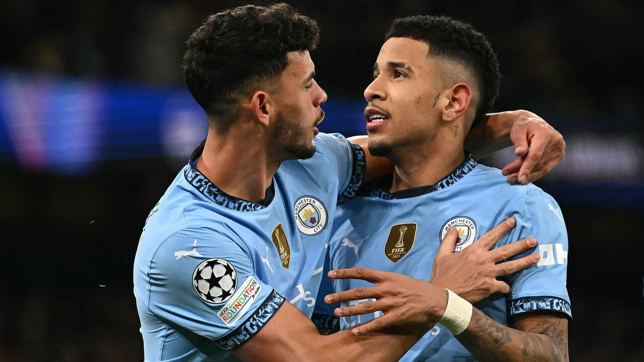 Manchester City's Brazilian midfielder #26 Savinho (R) celebrates with Manchester City's Portuguese midfielder #27 Matheus Nunes after scoring the team's third goal during the UEFA Champions League football match between Manchester City and Club Brugge at the Etihad Stadium in Manchester, north west England, on January 29, 2025.