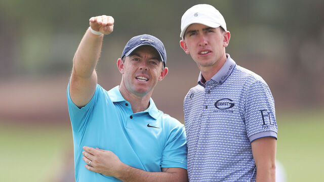 DUBAI, UNITED ARAB EMIRATES - NOVEMBER 15: Rory McIlroy of Northern Ireland interacts with Tom McKibbin of Northern Ireland on the 18th hole during a practice round prior to the DP World Tour Championship on the Earth Course at Jumeirah Golf Estates on November 15, 2023 in Dubai, United Arab Emirates.
