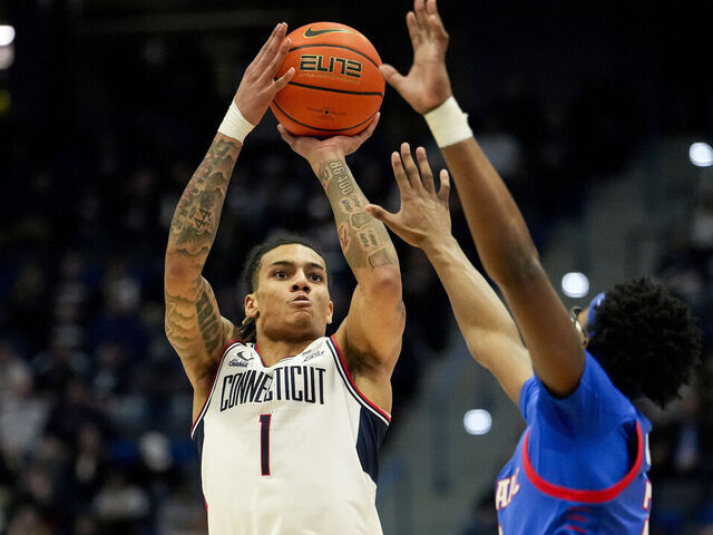HARTFORD, CONNECTICUT - JANUARY 29: Solo Ball #1 of the Connecticut Huskies shoots against Layden Blocker #2 of the DePaul Blue Demons during the first half of an NCAA basketball game at the XL Center on January 29, 2025 in Hartford, Connecticut.