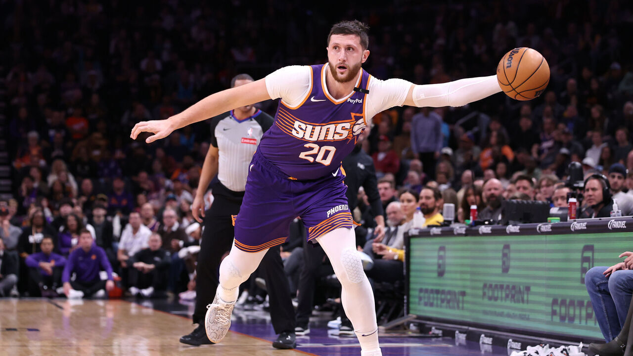 PHOENIX, ARIZONA - DECEMBER 27: Jusuf Nurkic #20 of the Phoenix Suns attempts to control a loose ball during the game against the Dallas Mavericks at Footprint Center on December 27, 2024 in Phoenix, Arizona. The Mavericks defeated the Suns 98-89.