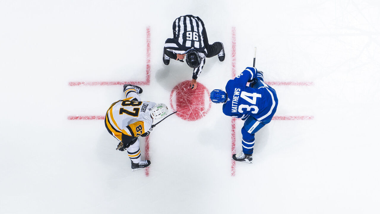 TORONTO, ON - OCTOBER 12: Auston Matthews #34 of the Toronto Maple Leafs and Sidney Crosby #87 of the Pittsburgh Penguins face off during the second period at the Scotiabank Arena on October 12, 2024 in Toronto, Ontario, Canada.