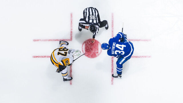 TORONTO, ON - OCTOBER 12: Auston Matthews #34 of the Toronto Maple Leafs and Sidney Crosby #87 of the Pittsburgh Penguins face off during the second period at the Scotiabank Arena on October 12, 2024 in Toronto, Ontario, Canada.