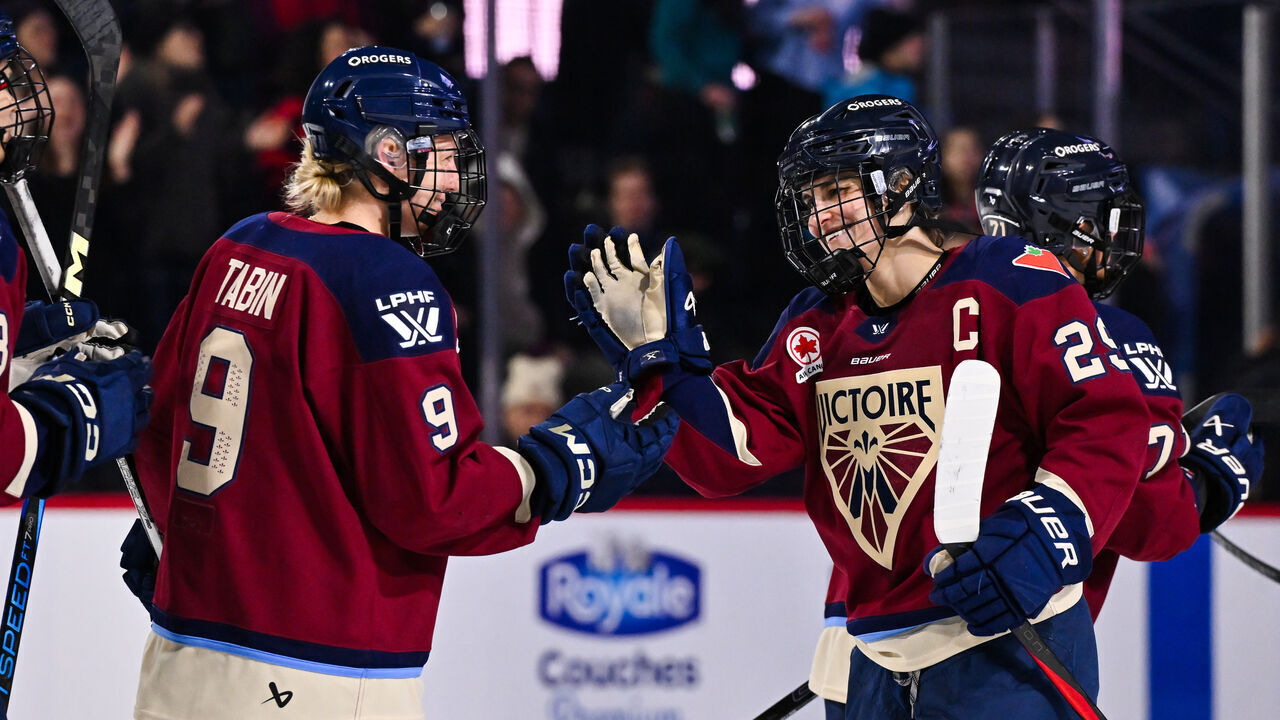 LAVAL, CANADA - JANUARY 29: Kati Tabin #9 and teammate Marie-Philip Poulin #29 of the Montreal Victoire celebrate a victory against the Ottawa Charge at Place Bell on January 29, 2025 in Laval, Quebec, Canada. The Montreal Victoire defeated the Ottawa Charge 4-1.