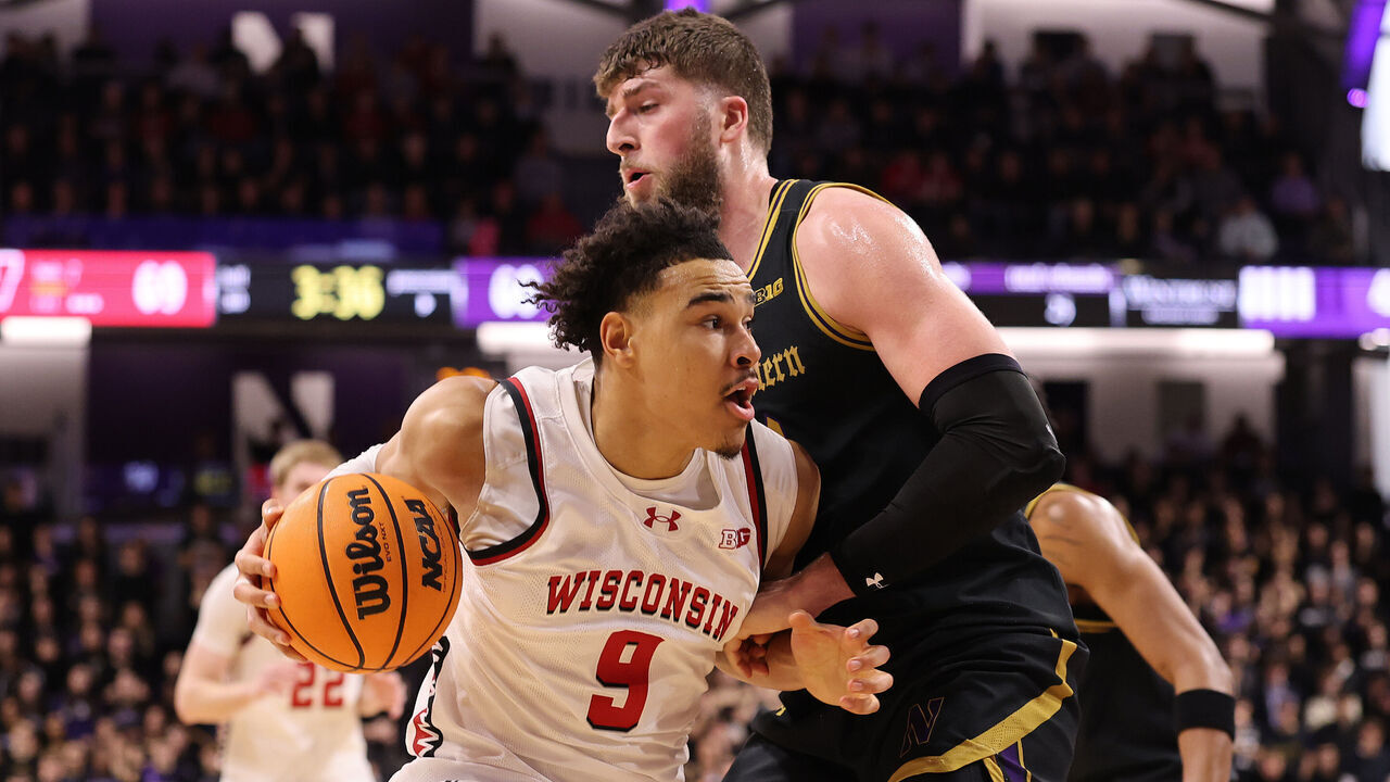 EVANSTON, ILLINOIS - FEBRUARY 01: John Tonje #9 of the Wisconsin Badgers drives to the basket against Matthew Nicholson #34 of the Northwestern Wildcats during the second half at Welsh-Ryan Arena on February 01, 2025 in Evanston, Illinois.