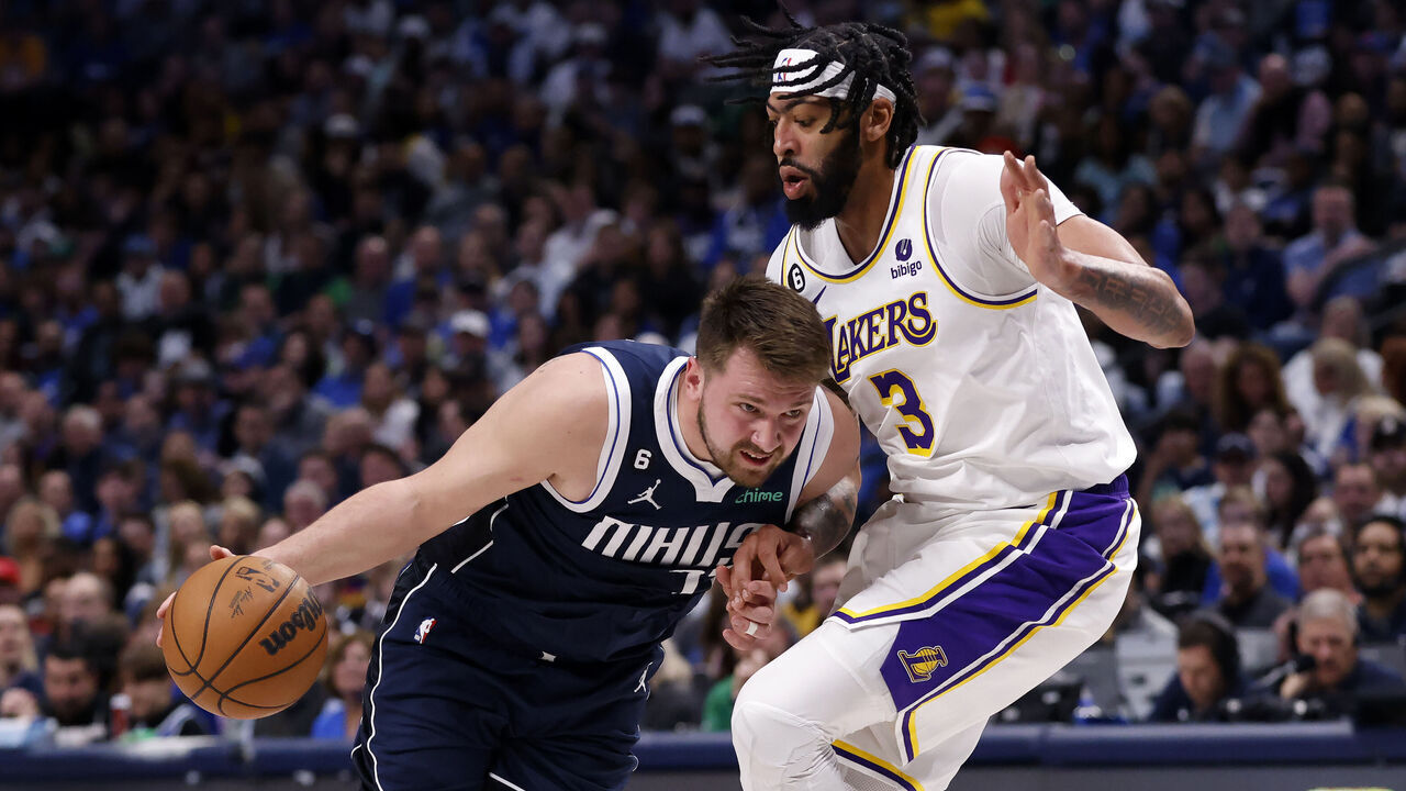 DALLAS, TX - FEBRUARY 26: Luka Doncic #77 of the Dallas Mavericks handles the ball against Anthony Davis #3 of the Los Angeles Lakers in the first half of the game at American Airlines Center on February 26, 2023 in Dallas, Texas.