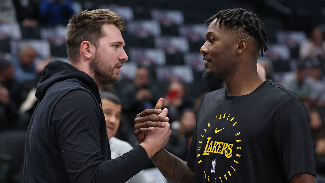 DALLAS, TX - JANUARY 7: Luka Doncic #77 of the Dallas Mavericks and Dorian Finney-Smith #17 of the Los Angeles Lakers high five before the game on January 7, 2025 at American Airlines Center in Dallas, Texas. Mandatory Copyright Notice: Copyright 2025 NBAE