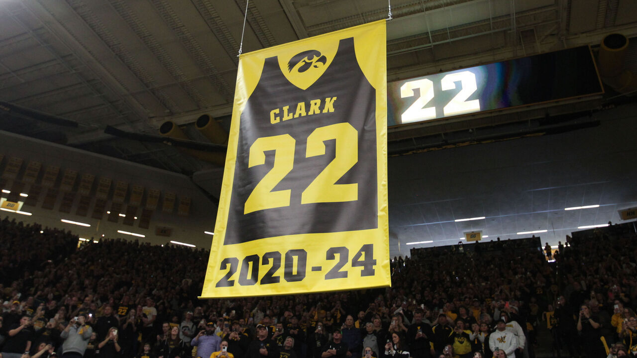 IOWA CITY, IOWA- FEBRUARY 2: A banner to honor former Iowa Hawkeye guard and current Indiana Fever guard Caitlin Clark #22 is hoisted to the ceiling during a ceremony to retire her #22 following the match-up against the USC Trojans, at Carver-Hawkeye Arena on February 2, 2025 in Iowa City, Iowa.