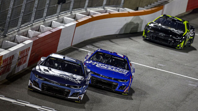 WINSTON SALEM, NORTH CAROLINA - FEBRUARY 02: Michael McDowell, driver of the #71 Workforce Chevrolet and Kyle Larson, driver of the #5 HendrickCars.com Chevrolet race during the Last Chance Qualifier for the Cook Out Clash at Bowman Gray Stadium on February 02, 2025 in Winston Salem, North Carolina.