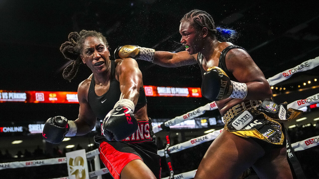 FLINT, MICHIGAN - FEBRUARY 02: Claressa Shields (R) punches Danielle Perkins during the ninth round of their undisputed heavyweight title bout on February 02, 2025 at Dort Financial Center in Flint, Michigan.