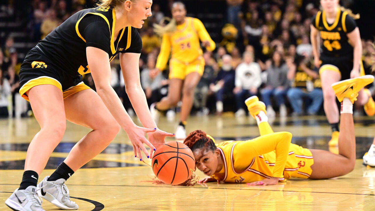 IOWA CITY, IA - FEBRUARY 02 - Iowa guard Sydney Affolter (3) picks up a loose ball as Southern Cal guard Kennedy Smith (11) looks on during a Big Ten Conference women's basketball game between the USC Trojans and the Iowa Hawkeyes on February 02, 2025, at Carver-Hawkeye Arena, Iowa City, IA.