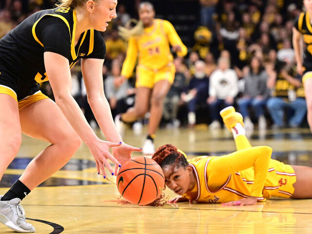 IOWA CITY, IA - FEBRUARY 02 - Iowa guard Sydney Affolter (3) picks up a loose ball as Southern Cal guard Kennedy Smith (11) looks on during a Big Ten Conference women's basketball game between the USC Trojans and the Iowa Hawkeyes on February 02, 2025, at Carver-Hawkeye Arena, Iowa City, IA.