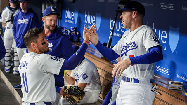 Los Angeles, CA, Tuesday, September 24, 2024 - Los Angeles Dodgers first base Freddie Freeman (5) and shortstop Miguel Rojas in the dugout during a game against the San Diego Padres at Dodger Stadium. (Robert Gauthier/Los Angeles Times via Getty Images)
