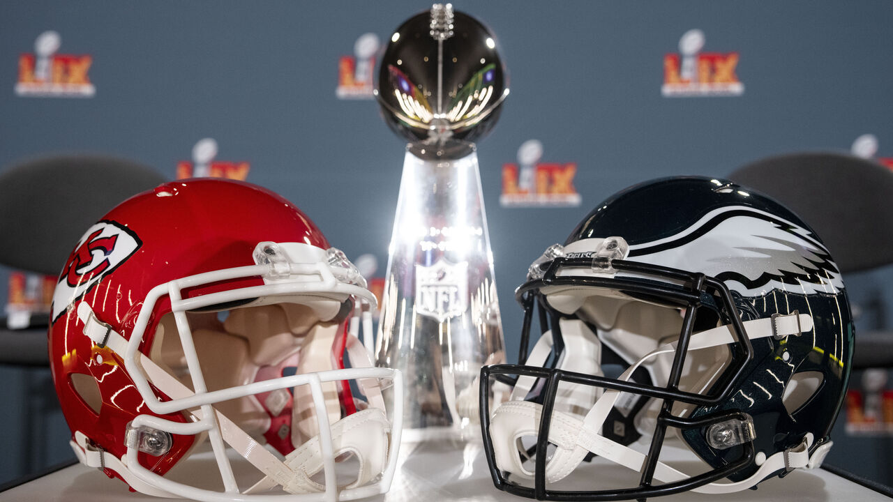 NEW ORLEANS, LOUISIANA - FEBRUARY 03: A detail shot of the Lombardi Trophy next to Kansas City Chiefs and Philadelphia Eagles helmets prior to a news conference on February 03, 2025 in New Orleans, Louisiana ahead of the NFL Super Bowl LIX football game between the Philadelphia Eagles and the Kansas City Chiefs.