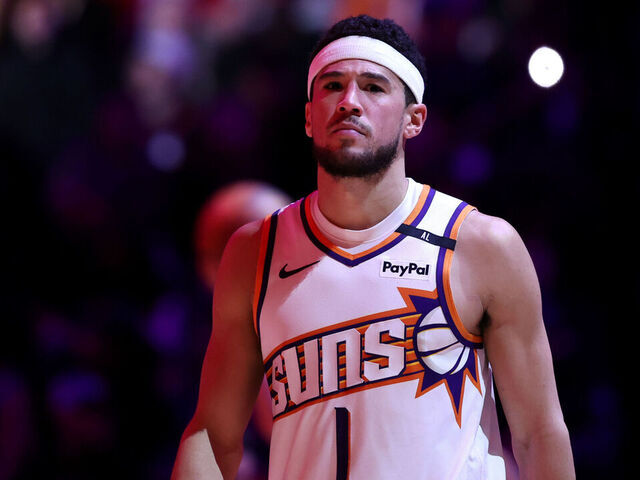 PHOENIX, ARIZONA - JANUARY 27: Devin Booker #1 of the Phoenix Suns looks on during the game against the LA Clippers at Footprint Center on January 27, 2025 in Phoenix, Arizona. The Suns defeated the Clippers 111-109.