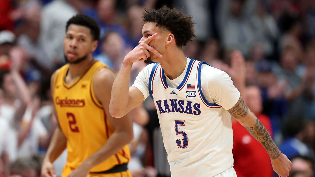 LAWRENCE, KANSAS - FEBRUARY 03: Joshua Jefferson #2 of the Iowa State Cyclones and Dajuan Harris Jr. #3 of the Kansas Jayhawks reach for a loose ball during the second half of the game at Allen Fieldhouse on February 03, 2025 in Lawrence, Kansas.