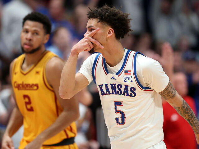 LAWRENCE, KANSAS - FEBRUARY 03: Joshua Jefferson #2 of the Iowa State Cyclones and Dajuan Harris Jr. #3 of the Kansas Jayhawks reach for a loose ball during the second half of the game at Allen Fieldhouse on February 03, 2025 in Lawrence, Kansas.