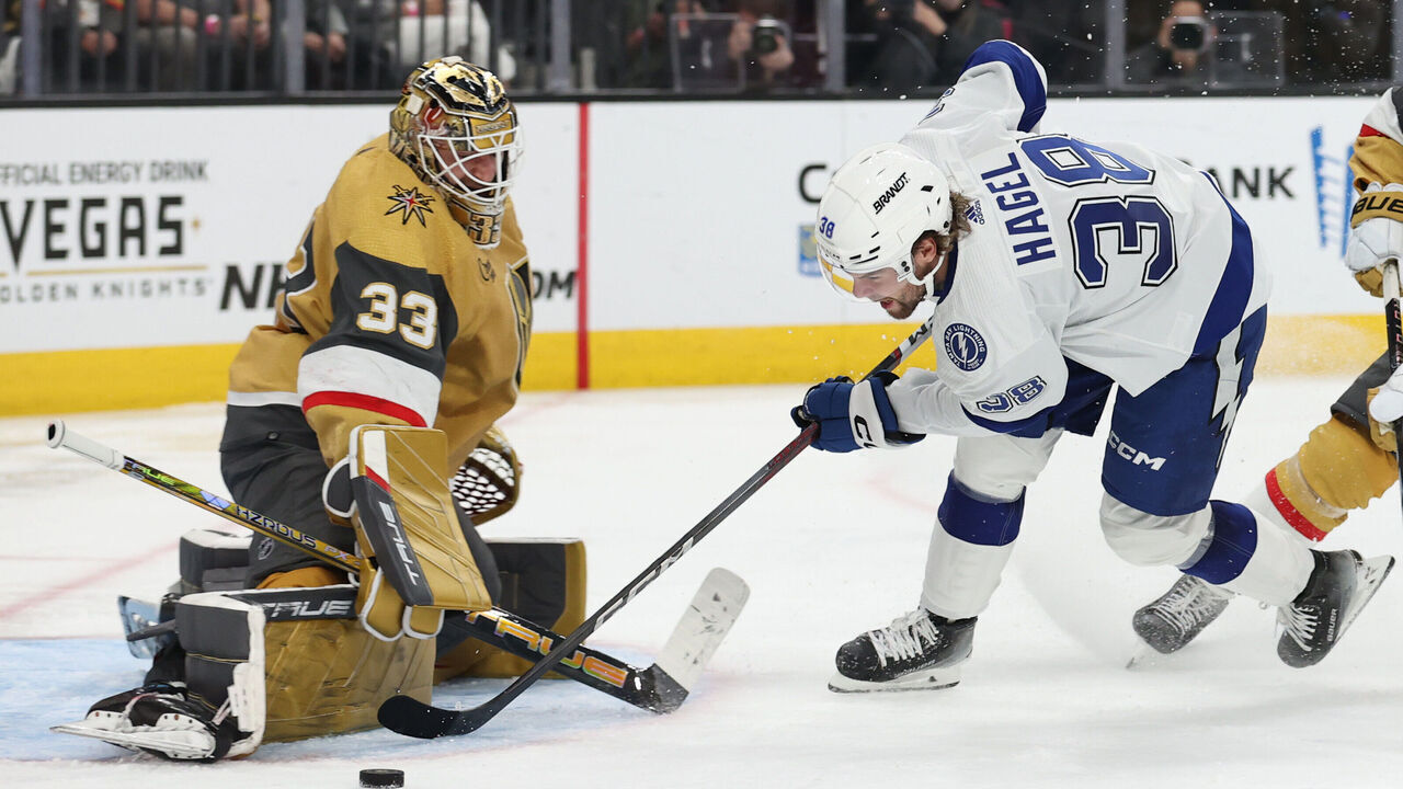 LAS VEGAS, NEVADA - MARCH 19: Adin Hill #33 of the Vegas Golden Knights stops an attempt by Brandon Hagel #38 of the Tampa Bay Lightning during the third period at T-Mobile Arena on March 19, 2024 in Las Vegas, Nevada.