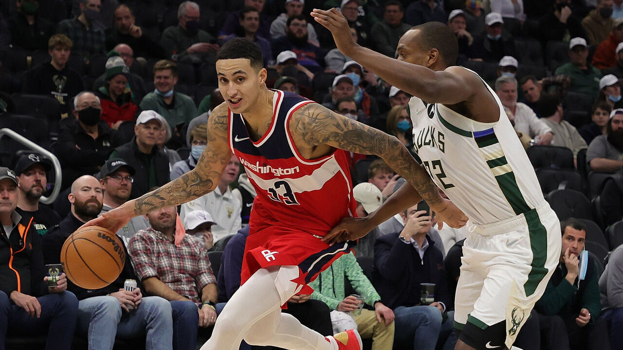 MILWAUKEE, WISCONSIN - FEBRUARY 01: Kyle Kuzma #33 of the Washington Wizards drives around Khris Middleton #22 of the Milwaukee Bucks during the second half of a game at Fiserv Forum on February 01, 2022 in Milwaukee, Wisconsin.