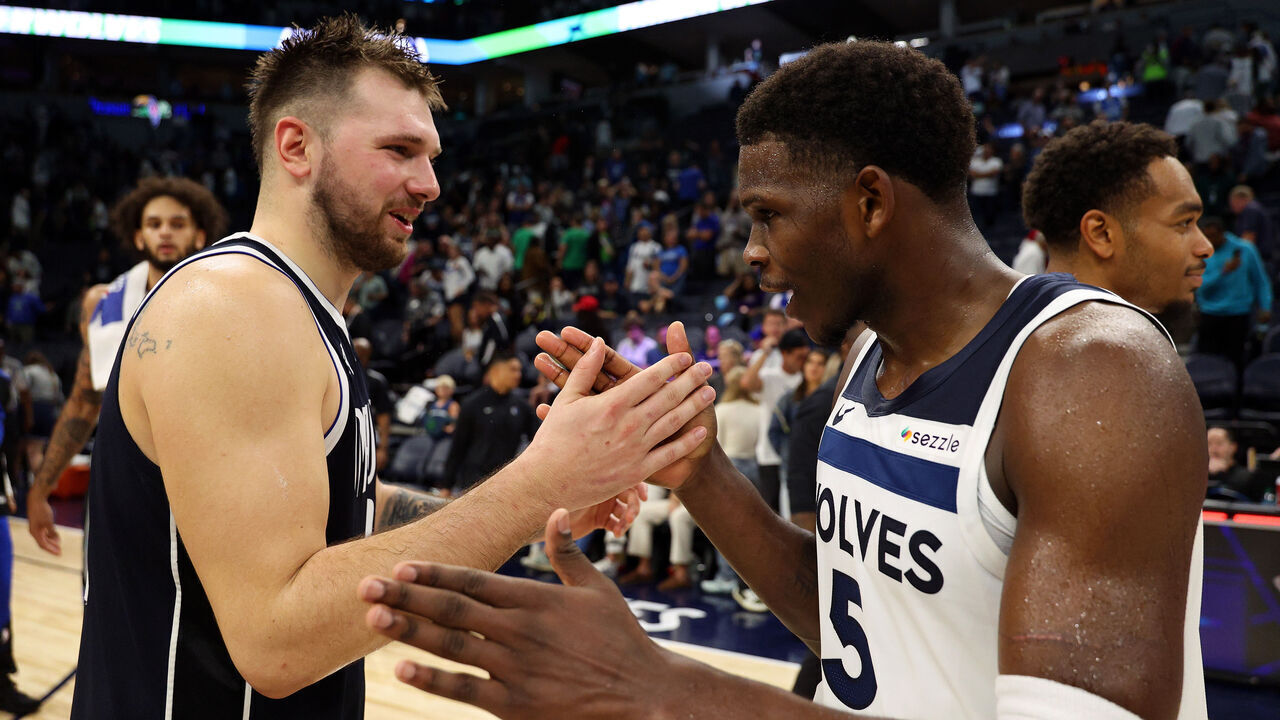 MINNEAPOLIS, MINNESOTA - OCTOBER 29: Luka Doncic #77 of the Dallas Mavericks and Anthony Edwards #5 of the Minnesota Timberwolves shake hands after the game at Target Center on October 29, 2024 in Minneapolis, Minnesota. The Mavericks defeated the Timberwolves 120-114.