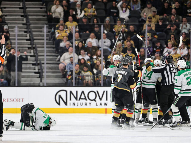 LAS VEGAS, NEVADA - JANUARY 28: Miro Heiskanen #4 of the Dallas Stars reacts after being injured on a hit from Mark Stone #61 of the Vegas Golden Knights as the teams scuffle behind him in the third period of their game at T-Mobile Arena on January 28, 2025 in Las Vegas, Nevada. Stone, who said he was tripped into Heiskanen, received a two-minute minor penalty for tripping on the play. The Stars defeated the Golden Knights 4-3 in overtime.