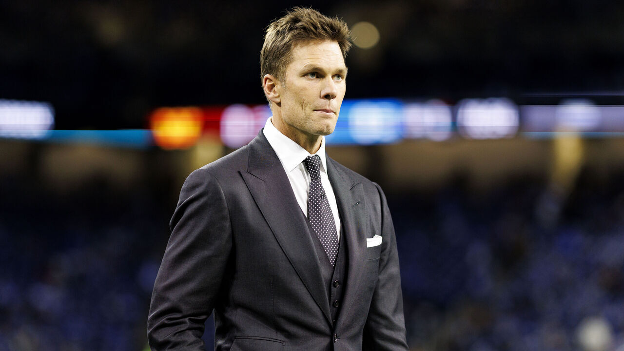 DETROIT, MICHIGAN - JANUARY 18: Fox Sports commentator Tom Brady stands on the field prior to the NFC Divisional Playoff game between the Washington Commanders and the Detroit Lions, at Ford Field on January 18, 2025 in Detroit, Michigan.