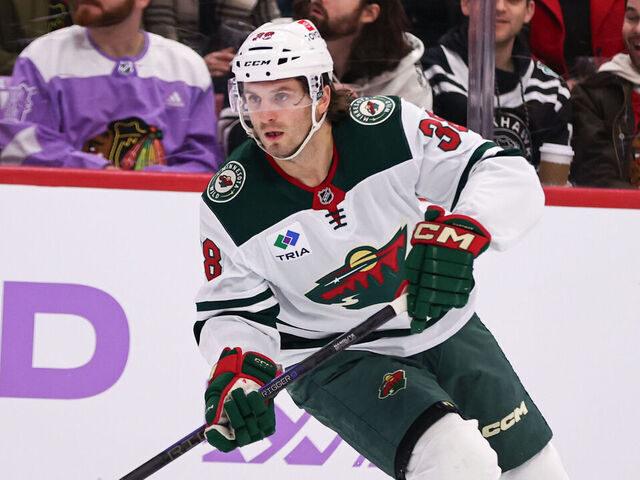 CHICAGO, IL - JANUARY 26: Ryan Hartman #38 of the Minnesota Wild controls the puck during the first period against the Chicago Blackhawks on January 26, 2025 at the United Center in Chicago, Illinois.