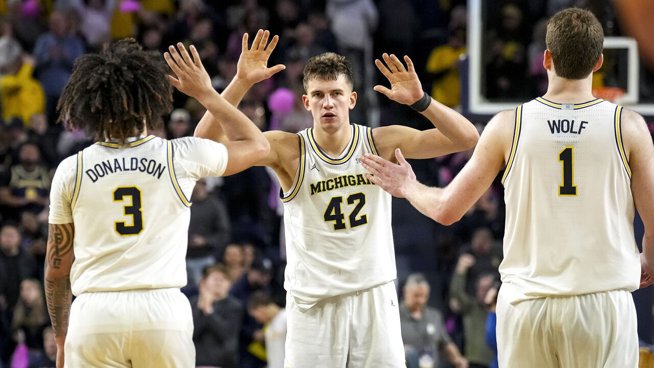ANN ARBOR, MICHIGAN - FEBRUARY 05: Tre Donaldson #3, Will Tschetter #42 and Danny Wolf #1 of the Michigan Wolverines celebrate their win against the Oregon Ducks at Crisler Arena on February 05, 2025 in Ann Arbor, Michigan.