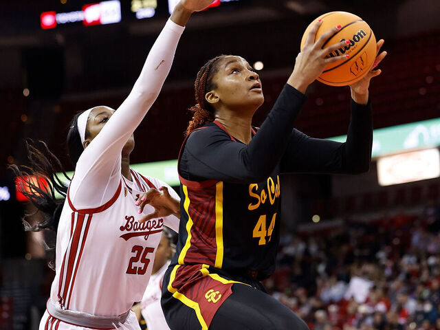 MADISON, WISCONSIN - FEBRUARY 05: Kiki Iriafen #44 of the USC Trojans scores past Serah Williams #25 of the Wisconsin Badgers during the first half of the game at Kohl Center on February 05, 2025 in Madison, Wisconsin.
