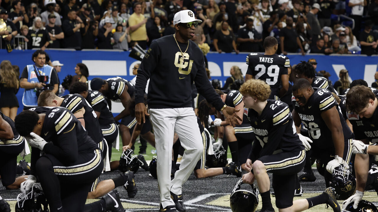 SAN ANTONIO, TX - DECEMBER 28: Deion Sanders head coach of the Colorado Buffaloes greets his team before the start of their game against the BYU Cougars in the Valero Alamo Bowl at Alamodome on December 28, 2024 in San Antonio, Texas.