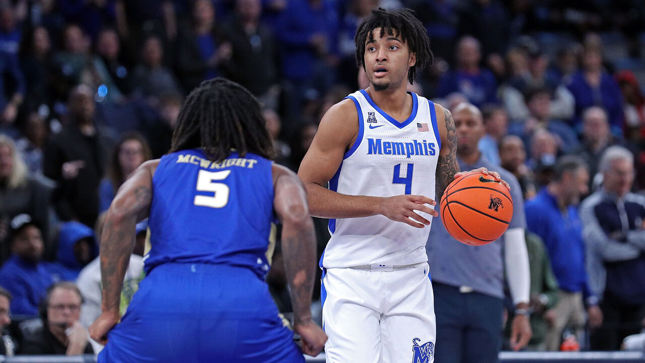 MEMPHIS, TENNESSEE - FEBRUARY 05: PJ Haggerty #4 of the Memphis Tigers handles the ball against Jesaiah McWright #5 of the Tulsa Golden Hurricane during the first half at FedExForum on February 05, 2025 in Memphis, Tennessee.