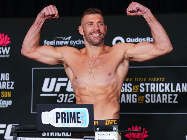 SYDNEY, AUSTRALIA - FEBRUARY 07: Dricus Du Plessis of South Africa poses on the scale during the UFC 312 official weigh-in at the Hilton Sydney on February 07, 2025 in Sydney, Australia.