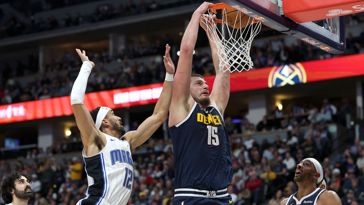 DENVER, COLORADO - FEBRUARY 06: Nikola Jokic #15 of the Denver Nuggets dunks on Trevelin Queen #12 of the Orlando Magic in the third quarter at Ball Arena on February 06, 2025 in Denver, Colorado.
