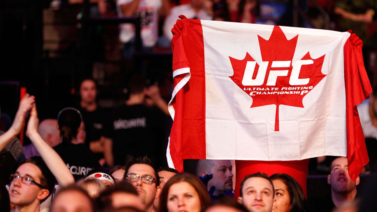 MONTREAL, QC - NOVEMBER 17: A fan holds up a canadian flag with a UFC logo on it during the fight between Alessio Sakara and Patrick Cote during UFC 154 on November 17, 2012 at the Bell Centre in Montreal, Canada.