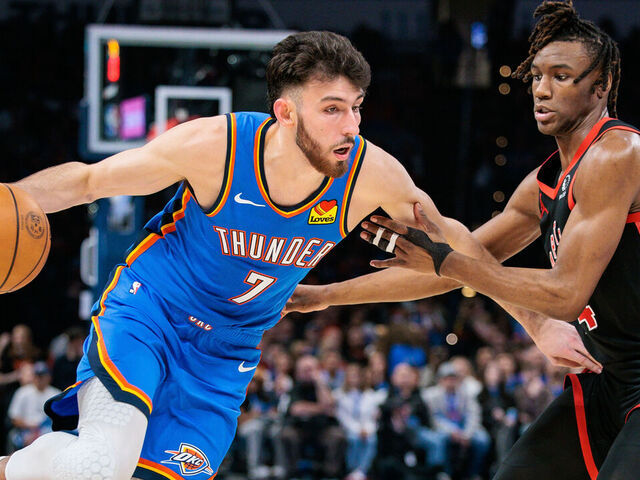 OKLAHOMA CITY, OKLAHOMA - FEBRUARY 07: Chet Holmgren #7 of the Oklahoma City Thunder drives by Ja'Kobe Walter #14 of the Toronto Raptors during the fourth quarter at Paycom Center on February 7, 2025 in Oklahoma City, Oklahoma.