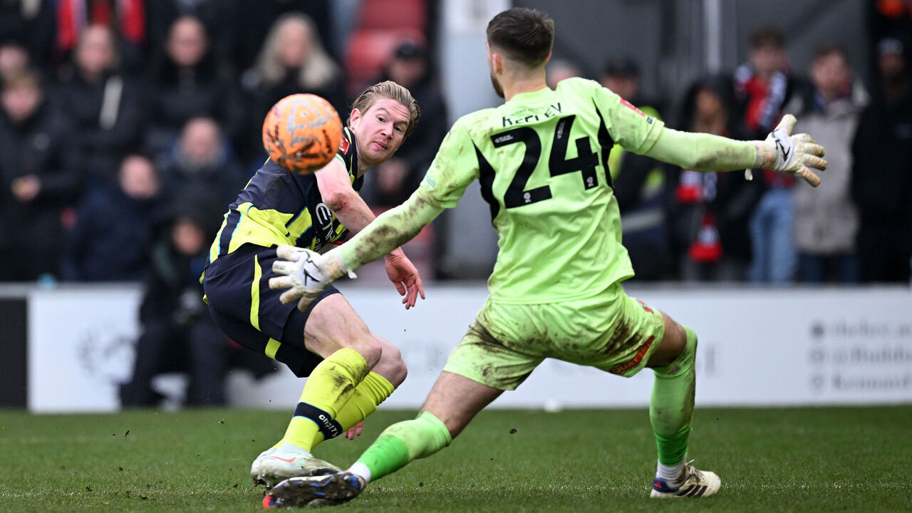 LONDON, ENGLAND - FEBRUARY 08: Kevin De Bruyne of Manchester City scores his team's second goal past Josh Keeley of Leyton Orient during the Emirates FA Cup Fourth Round match between Leyton Orient and Manchester City at Gaughan Group Stadium on February 08, 2025 in London, England.