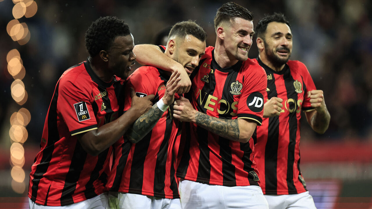 Nice's French defender #92 Jonathan Clauss (2L) is contratulated by teammates after scoring Nice's second goal during the French L1 football match between OGC Nice and RC Lens at the Allianz Riviera Stadium in Nice, south-eastern France, on February 8, 2025.